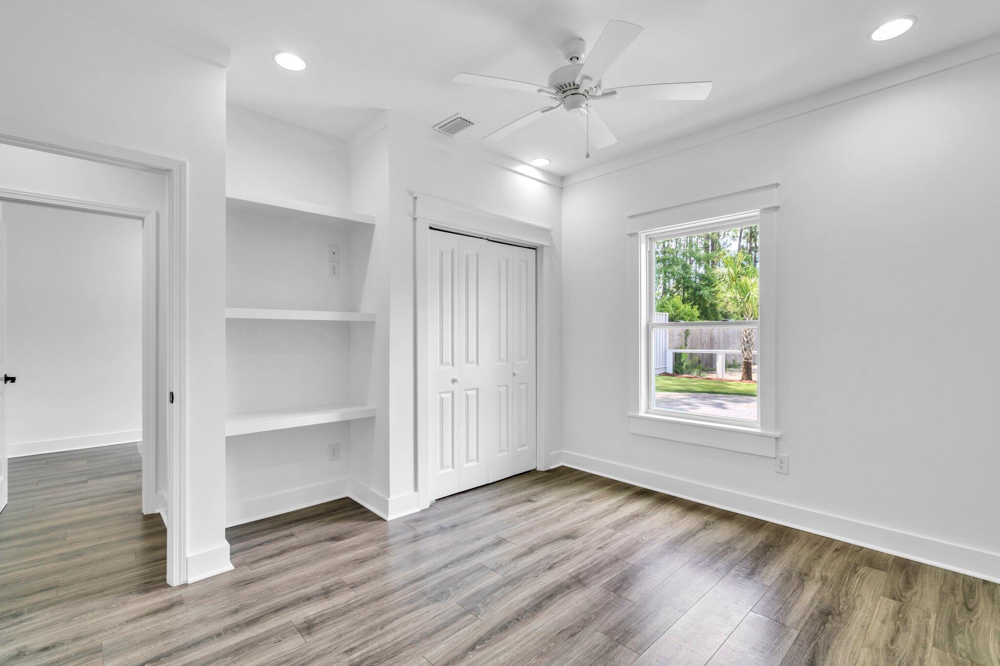 2672 Chat Holley Road Santa Rosa Beach, FL 32459 - Photo 42 of 53 a view of an empty room with a window and wooden floor