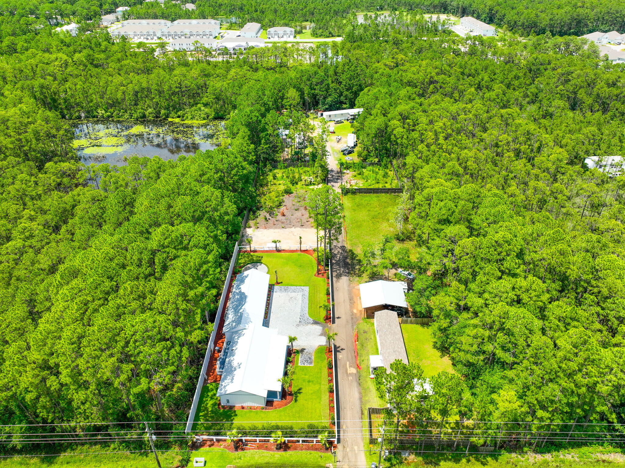 2672 Chat Holley Road Santa Rosa Beach, FL 32459 - Photo 49 of 53 a aerial view of a house with a yard and large trees