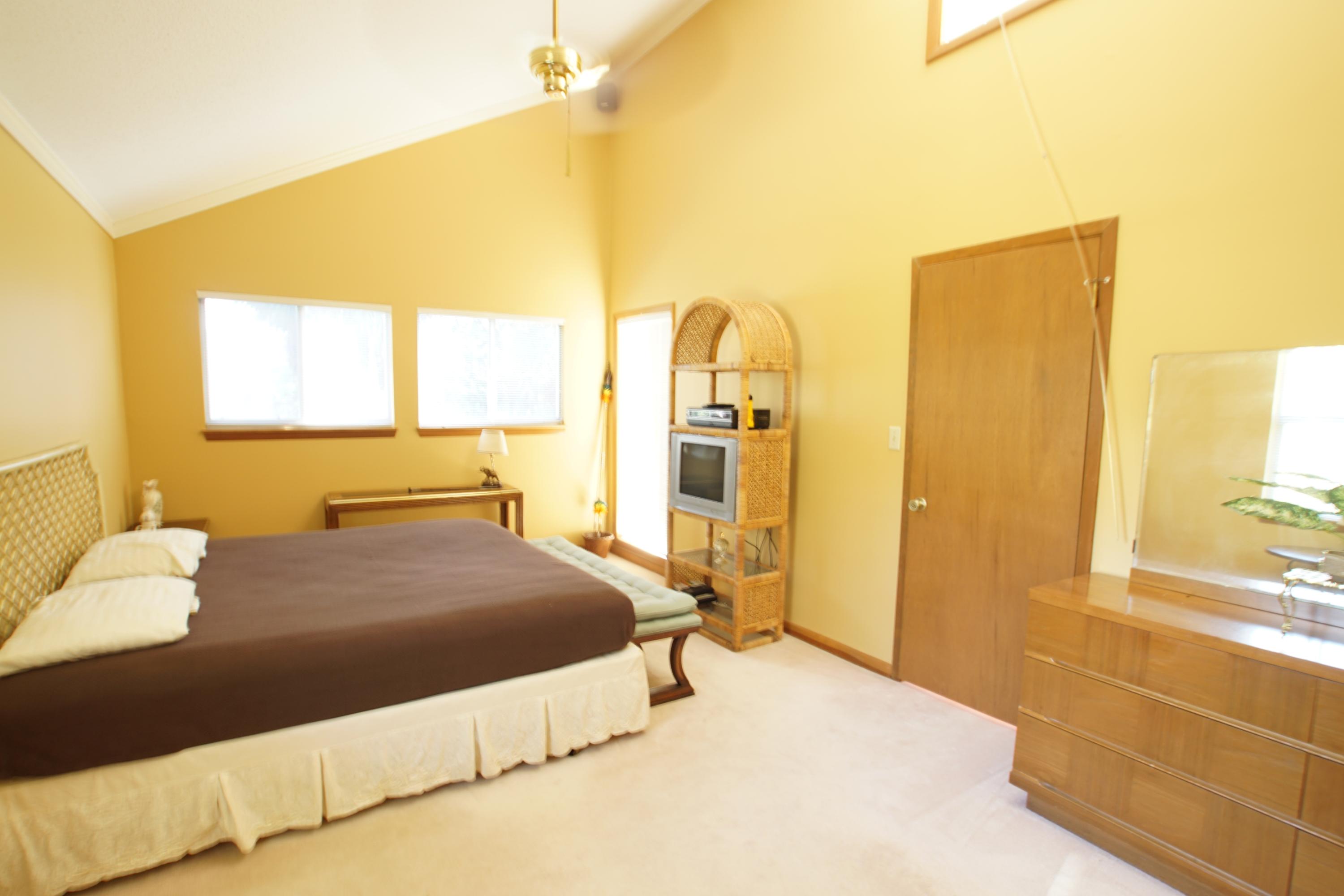 240 7th Street Santa Rosa Beach, FL 32459 - Photo 14 of 50 a bedroom with a bed and wooden floor
