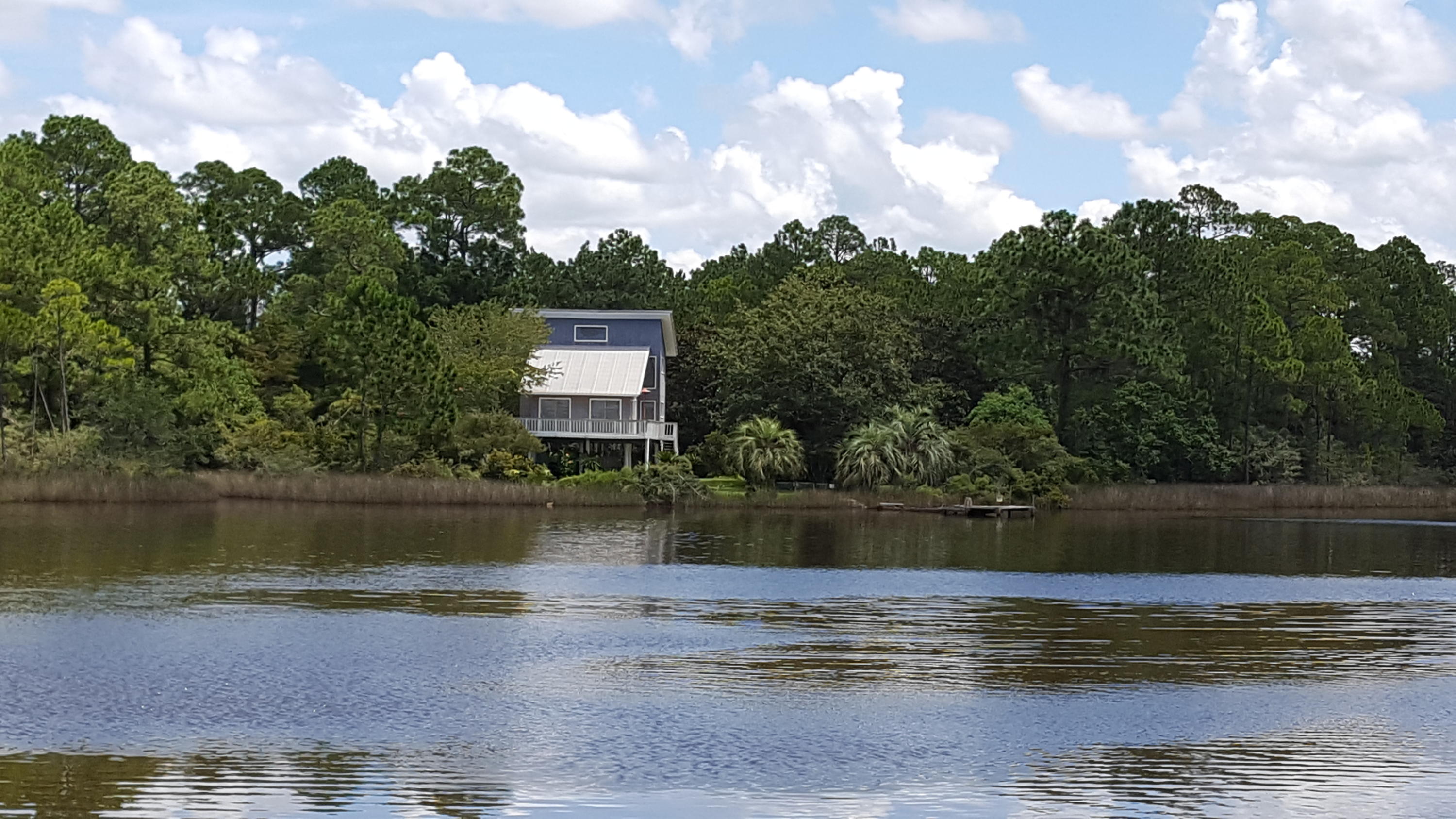 240 7th Street Santa Rosa Beach, FL 32459 - Photo 2 of 50 a view of a lake with a house in the background