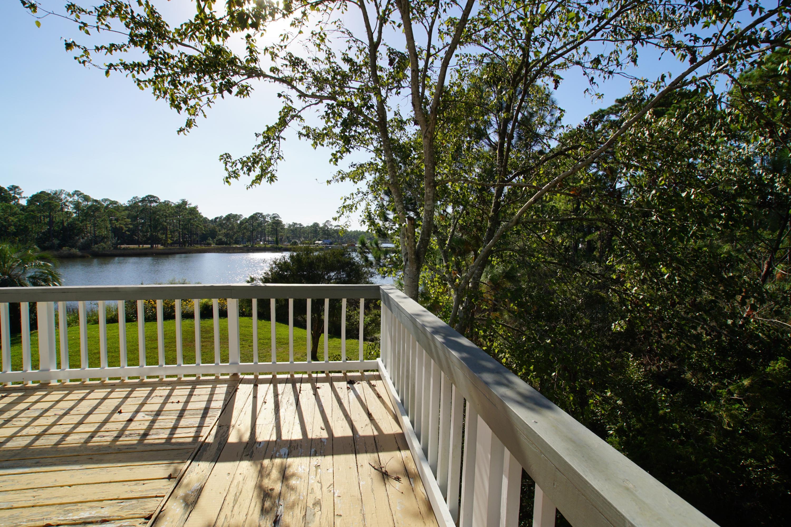 240 7th Street Santa Rosa Beach, FL 32459 - Photo 26 of 50 a view of balcony with wooden floor and fence