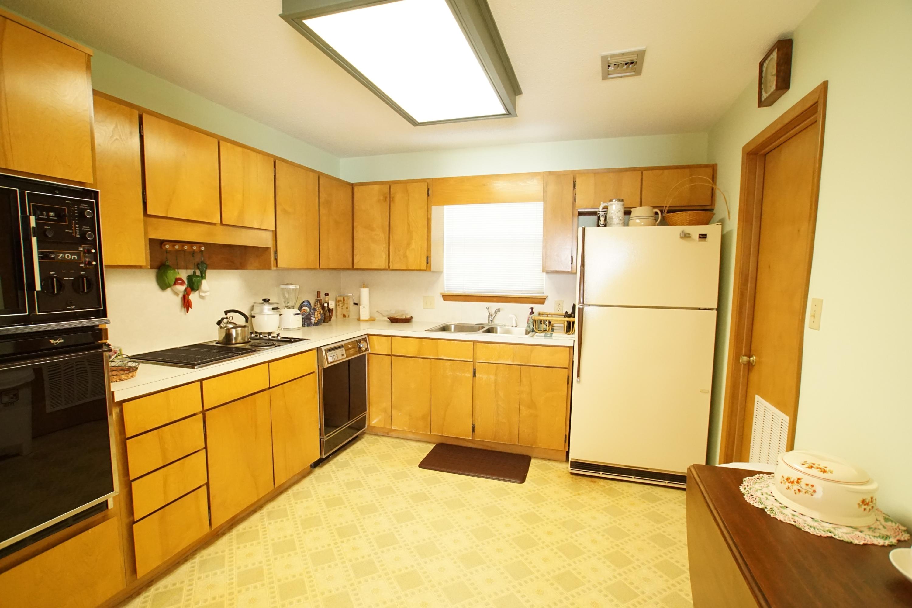240 7th Street Santa Rosa Beach, FL 32459 - Photo 10 of 50 a kitchen with a refrigerator sink stove and cabinets