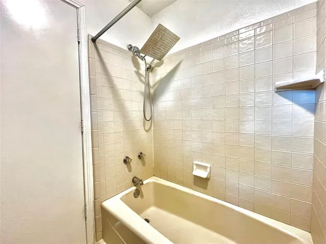 a bathroom with a bathtub and shower