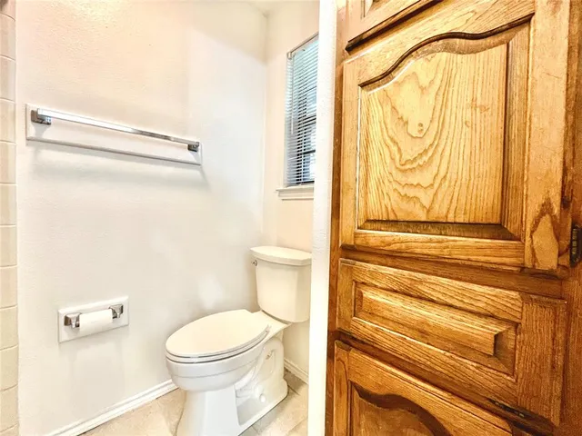 a bathroom with a toilet and a shower curtain