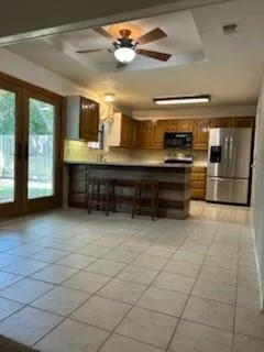 a large kitchen with cabinets and stainless steel appliances
