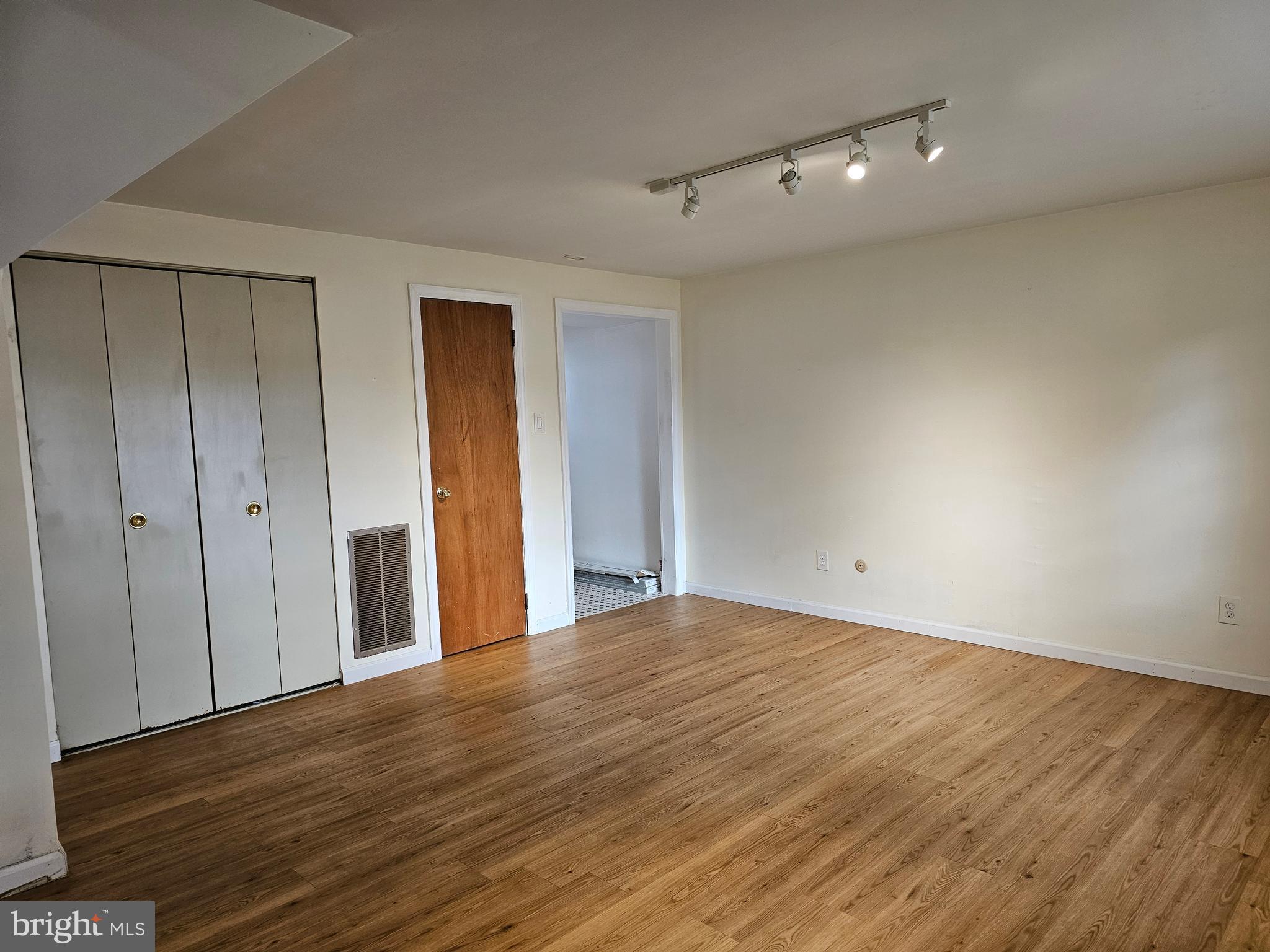 401 Cardinal Road Beverly, NJ 08010 - Photo 17 of 35 a view of an empty room with wooden floor
