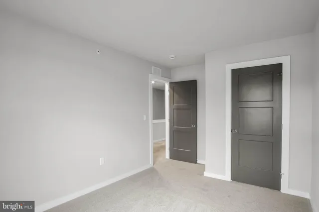 a view of an empty room and closet area