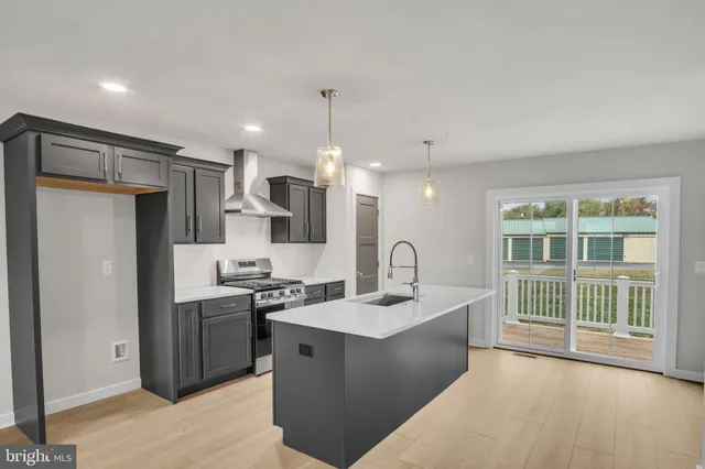 a kitchen with stainless steel appliances a sink stove and refrigerator