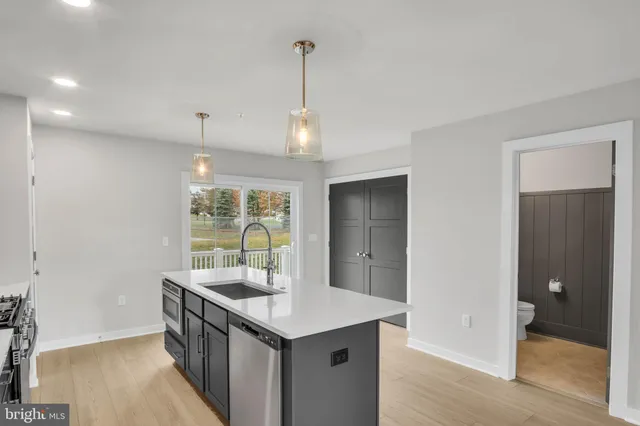 a kitchen with windows and refrigerator