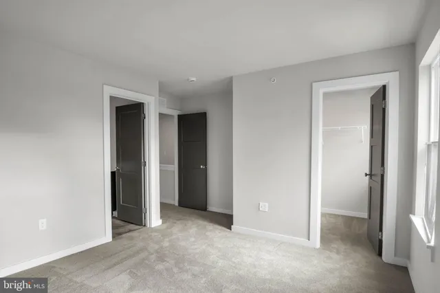 a view of an empty room and closet area