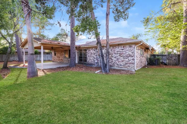 a view of a backyard with a garden and tree