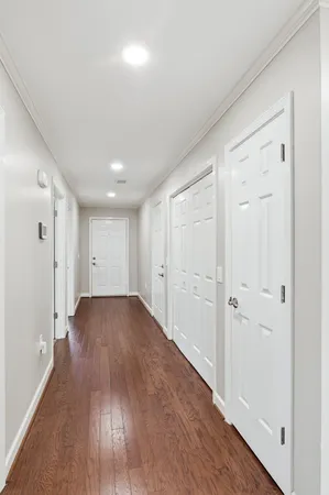 a view of a hallway with wooden floor
