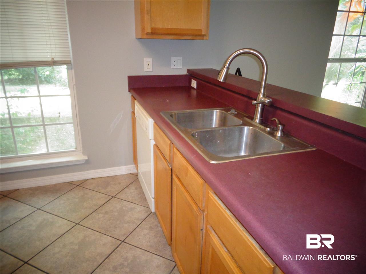 27020 Lake Road Orange Beach, AL 36561 - Photo 21 of 30 Kitchen. Refrigerator, dishwasher, stainless sink.
