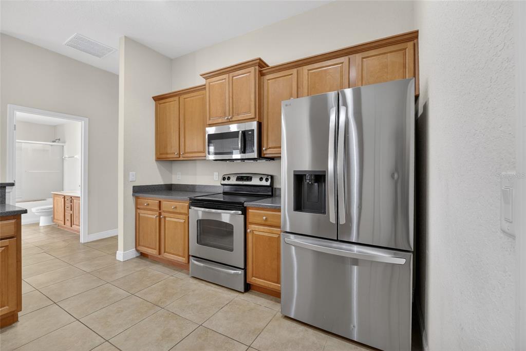 4319 Southwest 63rd Street Ocala, FL 34474 - Photo 10 of 29 a kitchen with stainless steel appliances a refrigerator stove and microwave