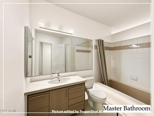 a bathroom with a sink a toilet a mirror and shower