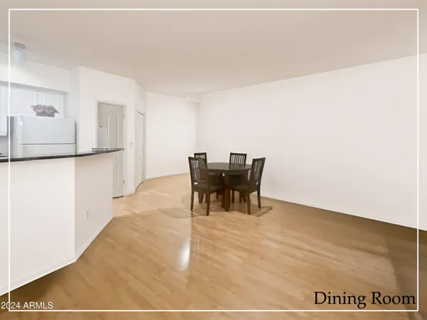 a dining room with furniture and a rug