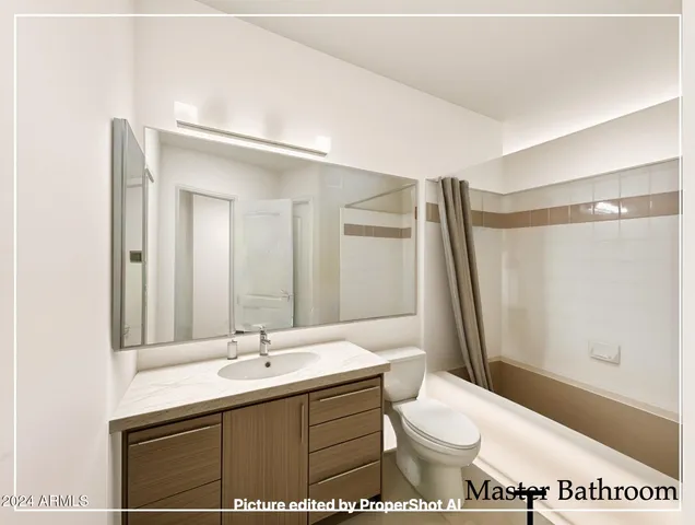 a bathroom with a sink toilet double vanity and shower