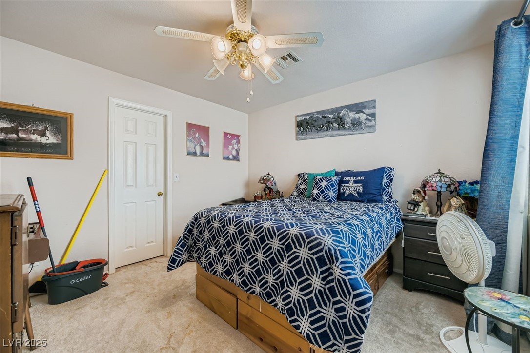 6800 West Elm Creek Drive, Unit 103 Las Vegas, NV 89108 - Photo 18 of 22 Carpeted bedroom featuring ceiling fan