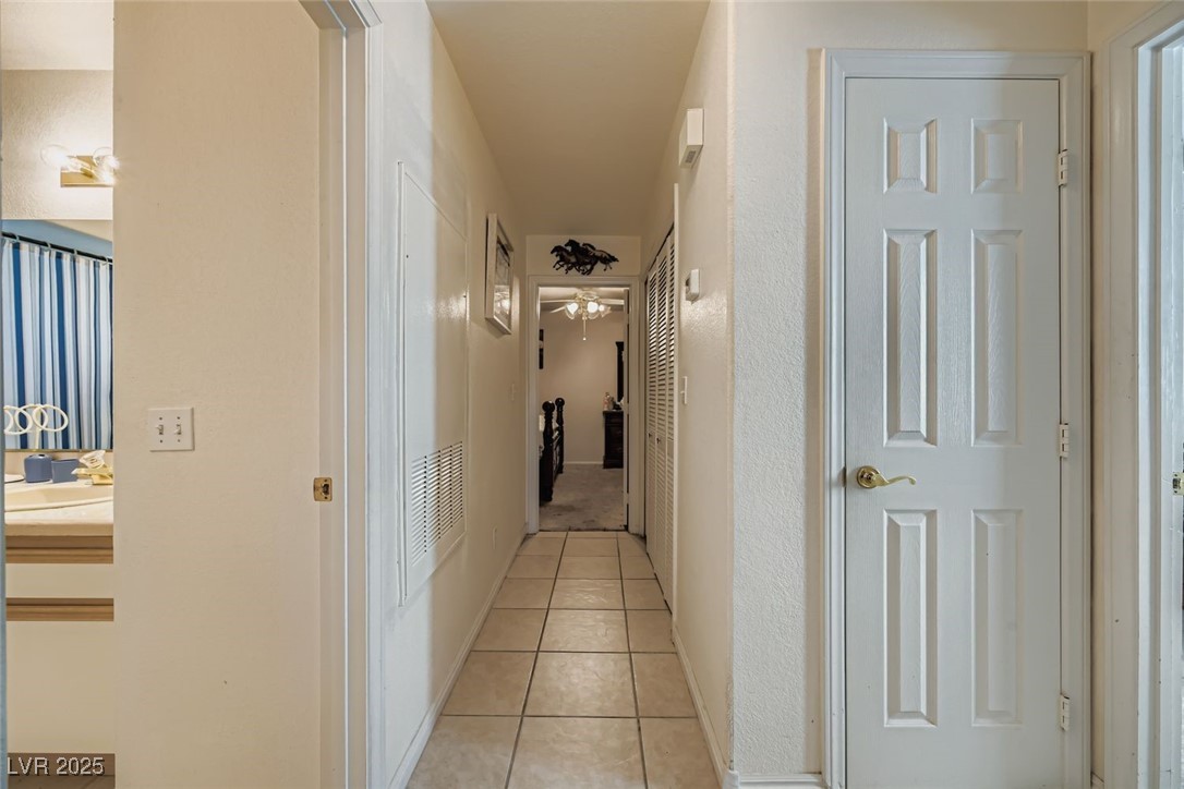 6800 West Elm Creek Drive, Unit 103 Las Vegas, NV 89108 - Photo 22 of 22 Hallway with light tile patterned floors and baseboards