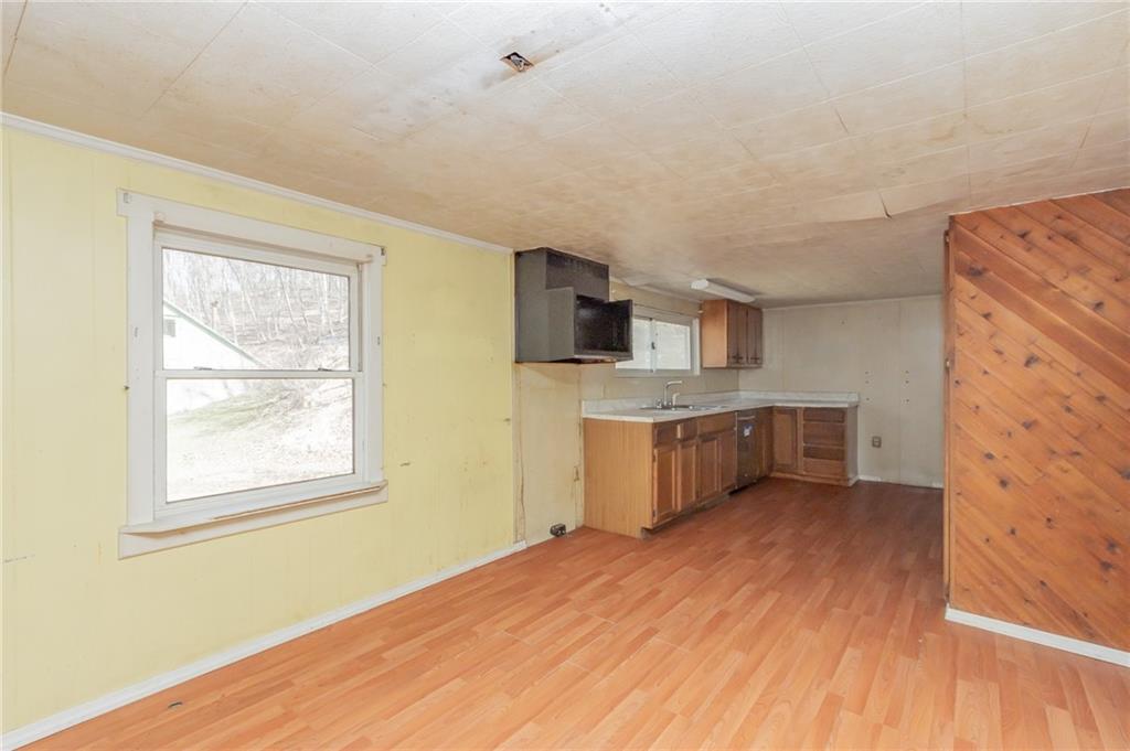 304 Baker Road Vandergrift, PA 15690 - Photo 7 of 18 a kitchen with stainless steel appliances a sink cabinets and wooden floor