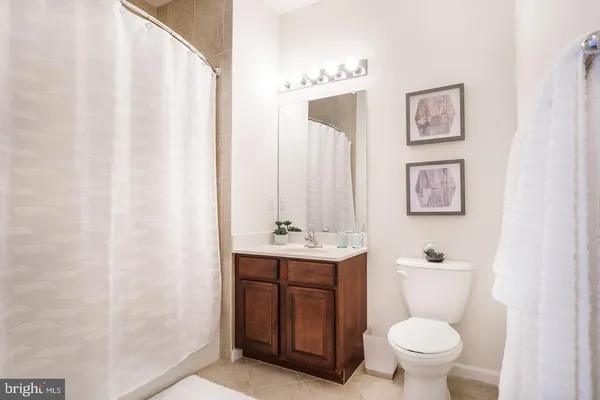 a bathroom with a toilet a sink and a mirror