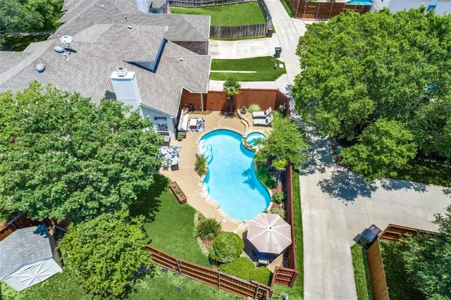 an aerial view of house with swimming pool and outdoor space