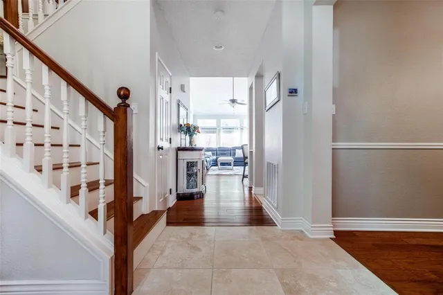 a view of an entryway with wooden floor and a livingroom view