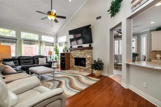 a living room with fireplace furniture and a flat screen tv