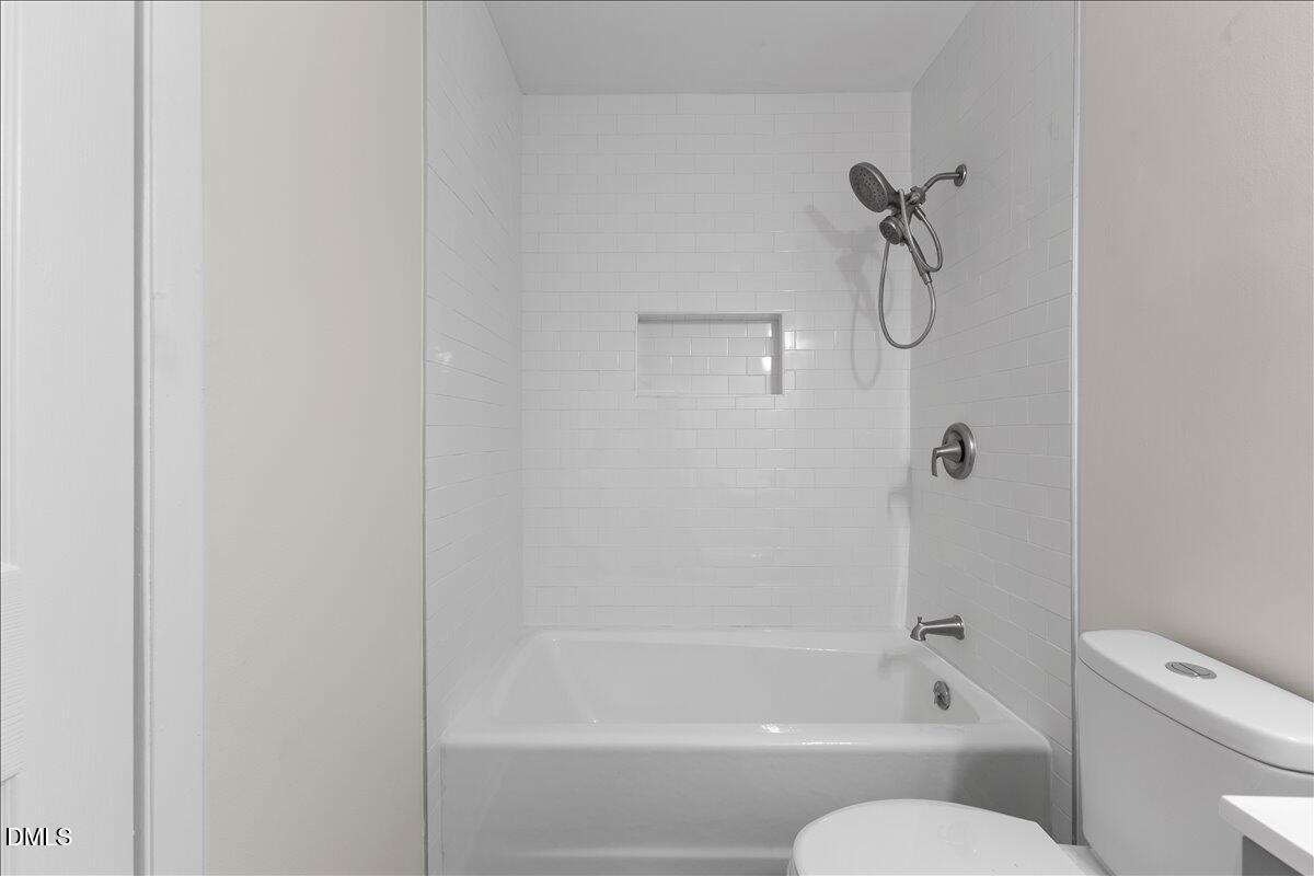 5806 Shady Grove Circle Raleigh, NC 27609 - Photo 23 of 28 a bathroom with a bathtub and a shower