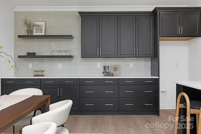 a kitchen with granite countertop a sink cabinets and stainless steel appliances