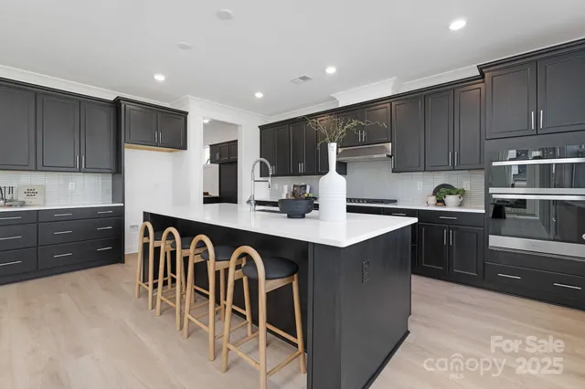 a kitchen with a sink refrigerator and cabinets