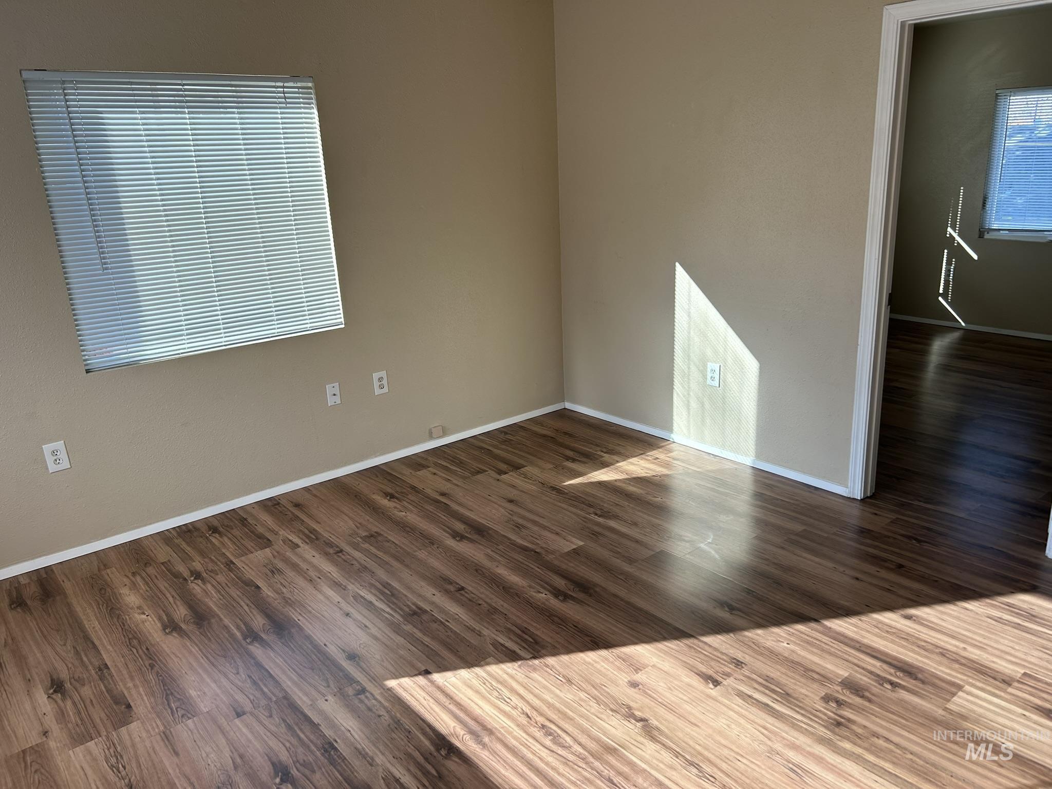 1413 7th Avenue Lewiston, ID 83501 - Photo 2 of 15 Empty room with dark wood finished floors and baseboards