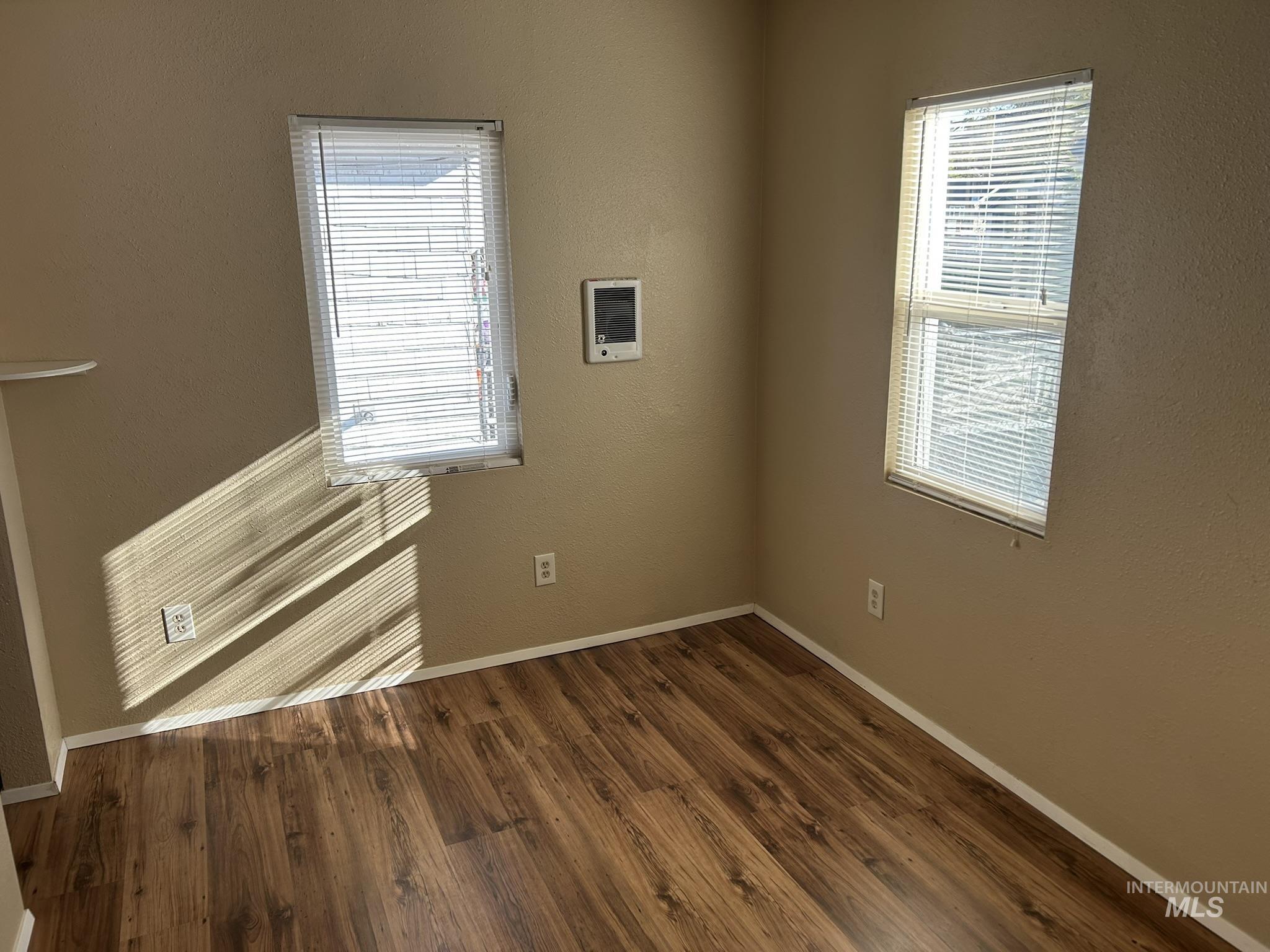 1413 7th Avenue Lewiston, ID 83501 - Photo 3 of 15 Spare room featuring a textured wall and dark wood-style flooring