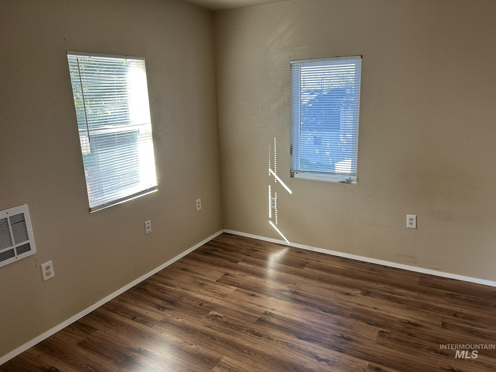 1413 7th Avenue Lewiston, ID 83501 - Photo 4 of 15 Unfurnished room with dark wood finished floors and baseboards