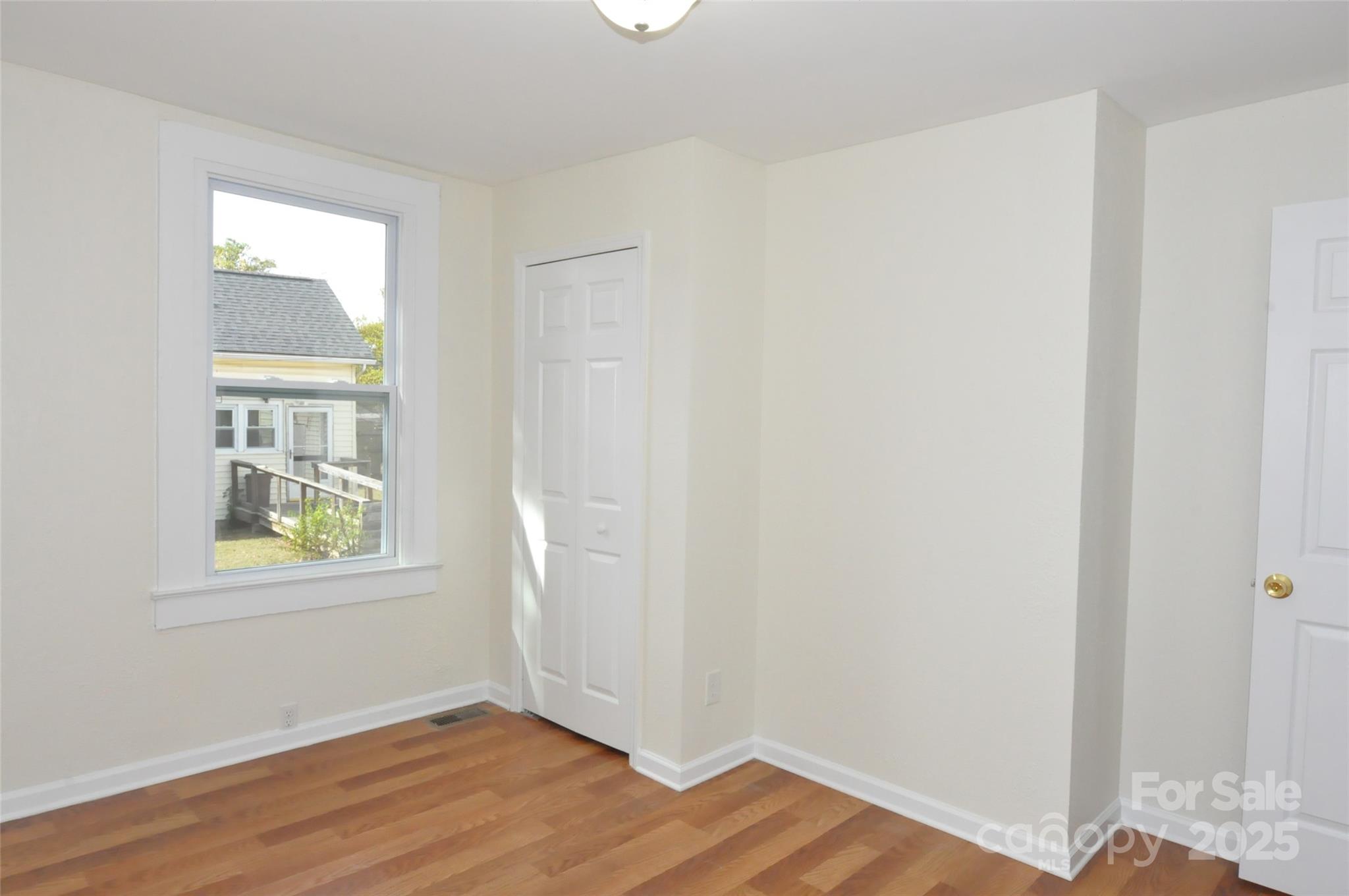 538 Pinckney Road Chester, SC 29706 - Photo 19 of 33 an empty room with wooden floor and windows