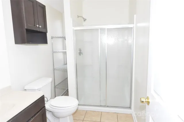a bathroom with a shower and a toilet