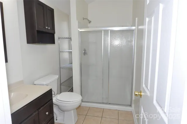 a bathroom with a toilet a sink and shower
