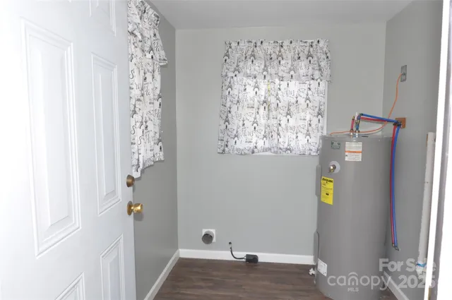 a view of bathroom with window and hallway