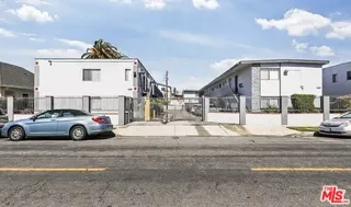 a view of a car park in front of a house