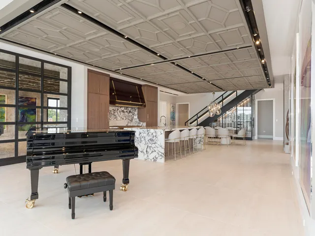 a large kitchen with stainless steel appliances granite countertop a stove and a sink