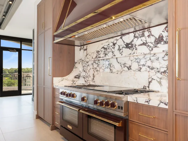 a kitchen with stainless steel appliances granite countertop a stove and a sink