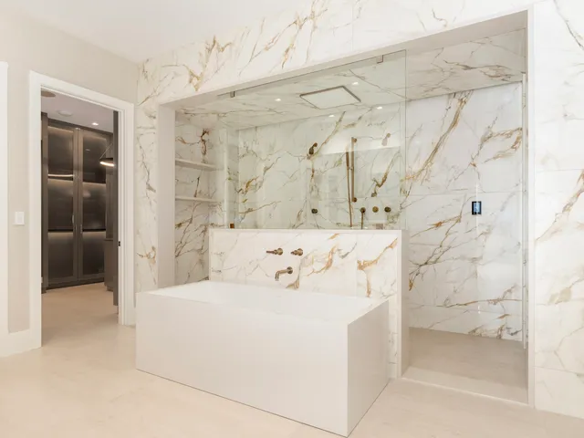 a bathroom with a shower sink and mirror