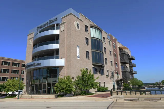 a bedroom with furniture and large window