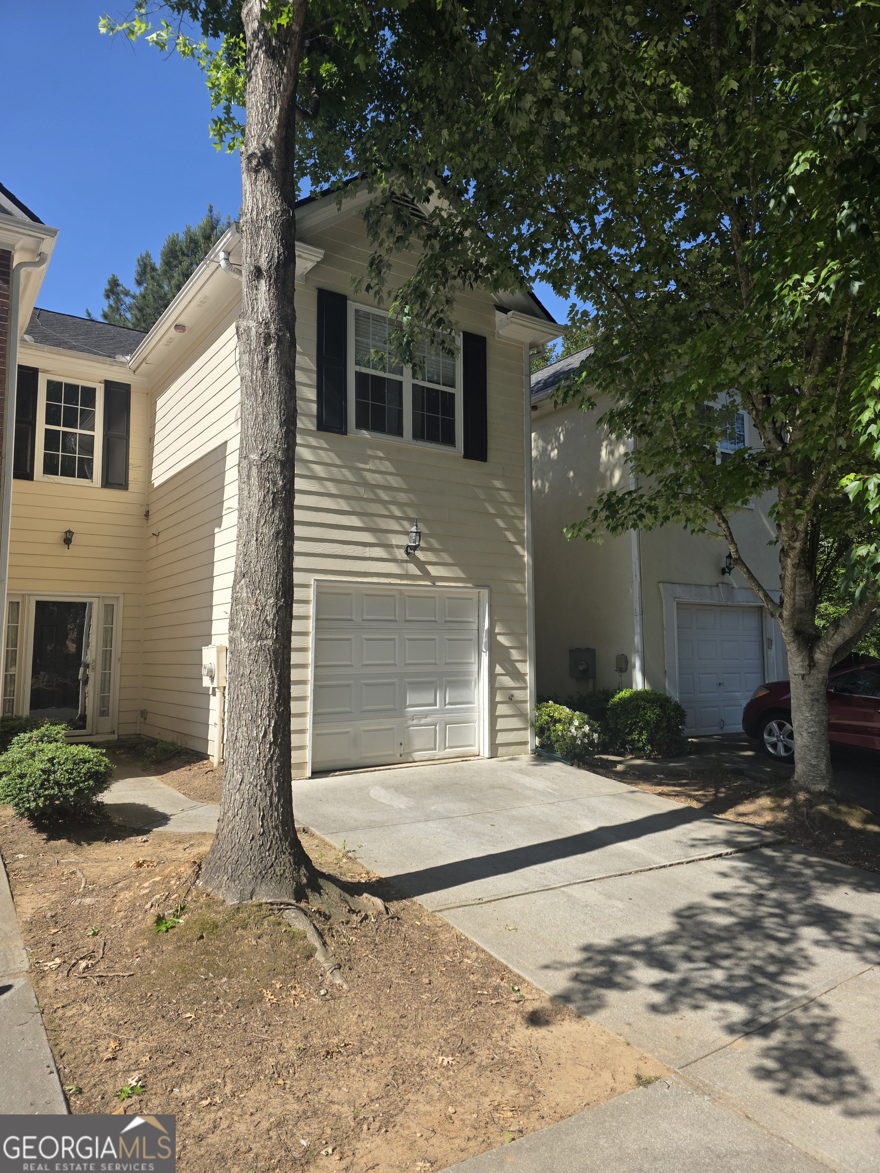 7005 Biltmore Trace Lithonia, GA 30058 - Photo 1 of 3 a front view of a house with a yard and garage