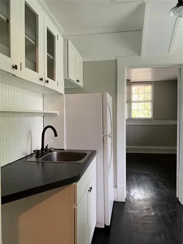 a kitchen with stainless steel appliances granite countertop a sink and a refrigerator