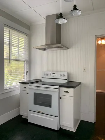 a kitchen with a stove and a window