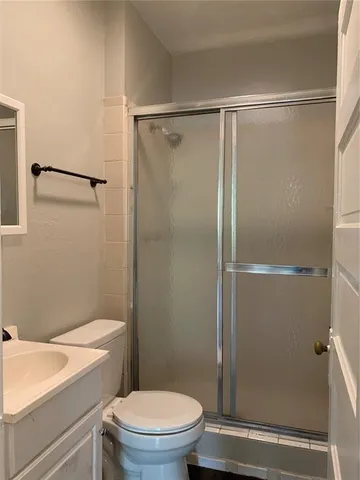 a bathroom with a toilet and a shower