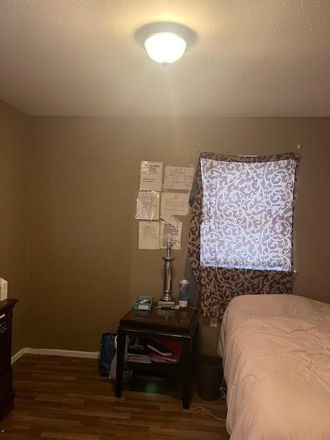 4026 Tioga Street Dallas, TX 75241 - Photo 13 of 13 a bed sitting in a bedroom next to a window