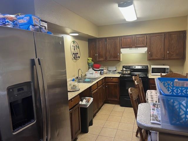 4026 Tioga Street Dallas, TX 75241 - Photo 3 of 13 a kitchen with stainless steel appliances granite countertop a refrigerator a stove a sink and a microwave