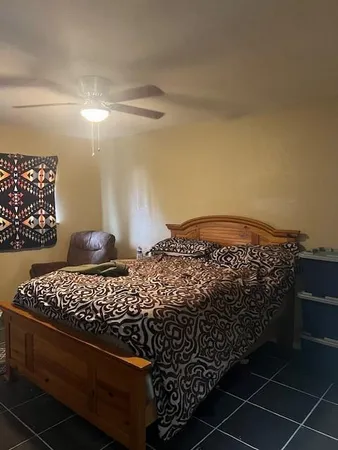 a bedroom with a bed and a window